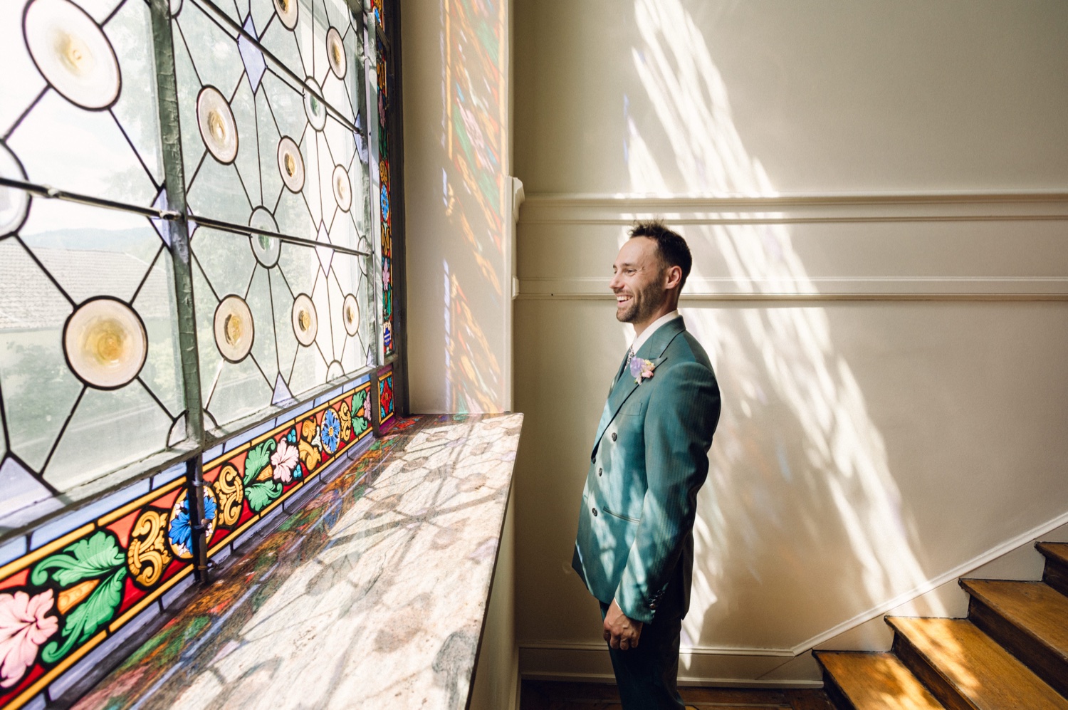 Photographe mariage Alsace – portrait du marié à la lumière d’un vitrail